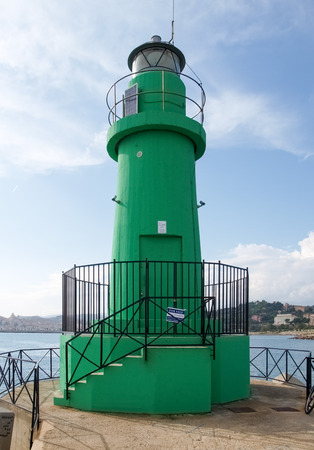 Oneglia, Italy - october 23, 2014: Green beacon located at the entrance of the harbor. Its color indicates to craft the direction to follow.の写真素材