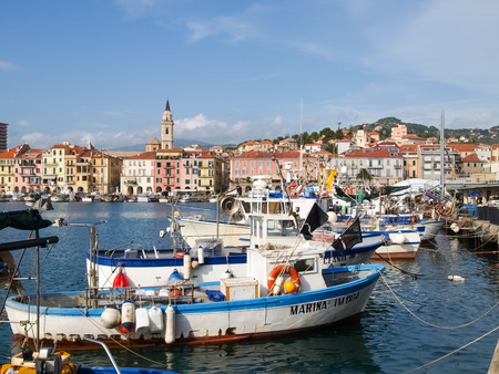 Oneglia, Italy - october 23, 2014: Marina and fishing. Several fishing boats are moored. In the background the buildings typical of Oneglia.のeditorial素材