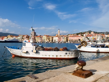 Oneglia, Italy - october 23, 2014: Marina and fishing. Several fishing boats are moored. In the background the buildings typical of Oneglia.のeditorial素材