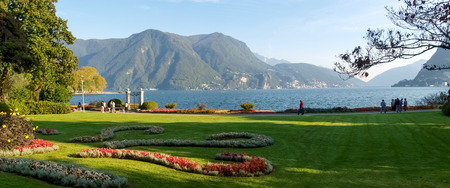 Lugano, Switzerland: Park of the City. Picture from the botanical park by the lake and surrounding mountains with flowersの写真素材