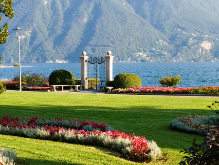 Lugano, Switzerland: Park of the City. Picture from the botanical park by the lake and surrounding mountains with flowersの写真素材