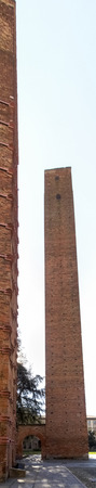 Pavia, Italy - March 8, 2015: Medieval towers in the historic center of the city. Especially the red brick used for the construction.のeditorial素材