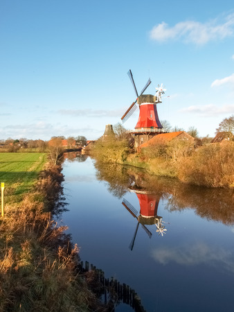 Greetsiel, Germany - December 6, 2014: Traditional Windmill working and still used to grind. The second mill is currently under renovation due to a violent hurricane.のeditorial素材
