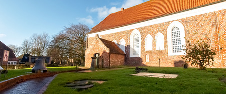 Greetsiel, Germany - December 6, 2014: Tourist town maintained as in antiquity. The typical houses are built of red brick. In the village there is a small harbor.のeditorial素材