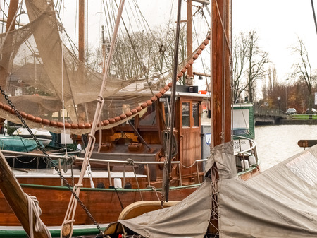 Leer, Germany - December 8, 2014: Ancient boats moored in the marina. The exposure to the public is...