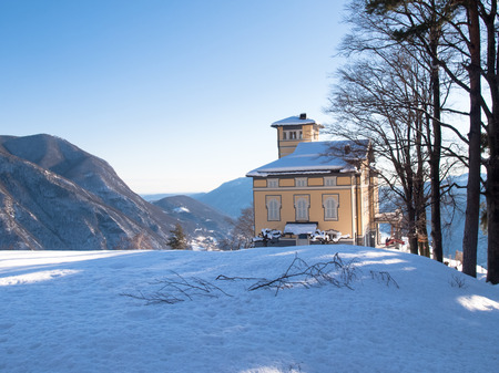 Monte Br, Switzerland - February 22. 2015: Winter landscape from Monte Bre. View of the summit restaurant, currently closed for the winter. Many tourists climb to the view of the Gulf of the cityのeditorial素材