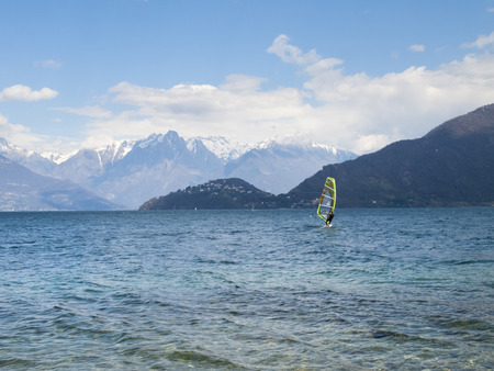 Pianello del Lario, Como - Italy - April 05, 2015: Windsurfer fun in a day of Breva the thermal wind typical of Lake Como during the spring / summer. The water temperature is slightly above the 10 degrees Celsius. The wind of around 16/18 knots.のeditorial素材