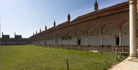 Certosa di Pavia, Italy - March 8, 2015: Large garden surrounded by the ancient dwellings of the monks. Each house separated from the others to keep the enclosure.のeditorial素材