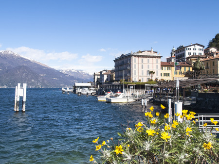 Bellagio lake of Como, Italy - April 1, 2015: Dock of Bellagio with nineteenth-century historic homes. The beautiful day is due to the wind from the north.のeditorial素材