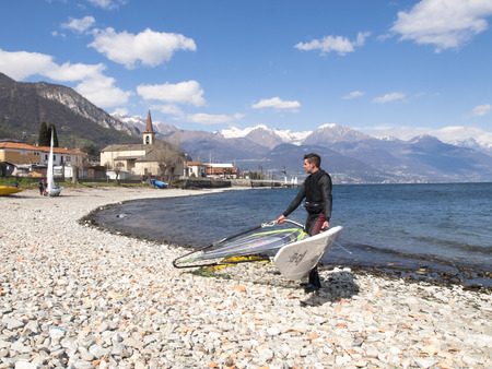 Pianello del Lario, Como - Italy - April 05, 2015: Windsurfer fun in a day of Breva the thermal wind typical of Lake Como during the spring / summer. The water temperature is slightly above the 10 degrees Celsius. The wind of around 16/18 knots.のeditorial素材