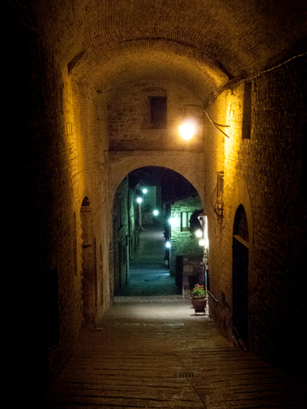 Italy, Gubbio - april 23, 2015: Evening pictures of the old town during a hot spring evening. The illuminations make partocolare the historic medieval villageのeditorial素材