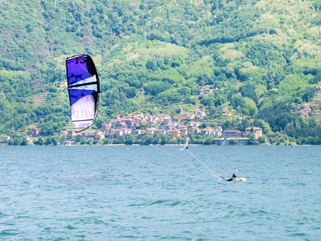 Pianello del ario, Italy - May 16, 2015: Kitesurfing action at the lake. Preparation, starting from the beach, sailing in the lake.のeditorial素材