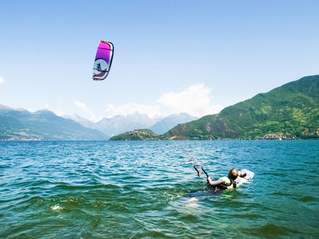 Pianello del ario, Italy - May 16, 2015: Kitesurfing action at the lake. Preparation, starting from the beach, sailing in the lake.のeditorial素材