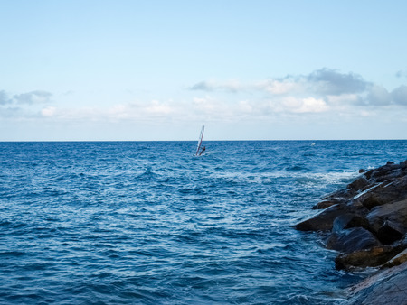 Oneglia, Italy - June 14, 2015: Windsurfing in the evening lightの写真素材