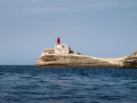Corsica, France: phare de la Madonetta on the white rock at the harbor entranceの写真素材
