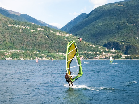 Cremia, Italy - September 5, 2015: Several windsurfing and kitesurfing with thermal wind from the south on Lake Como.のeditorial素材