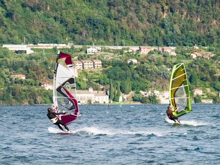 Cremia, Italy - September 5, 2015: Several windsurfing and kitesurfing with thermal wind from the south on Lake Como.のeditorial素材