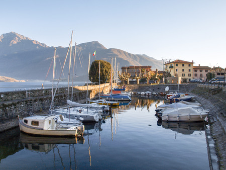 Gravedona, Italy: Promenade overlooking the small harbor and the surrounding mountains in the lake.のeditorial素材