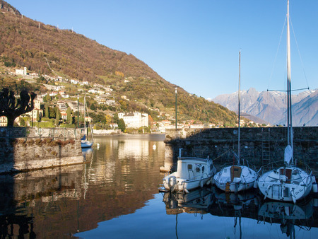 Gravedona, Italy: Promenade overlooking the small harbor and the surrounding mountains in the lake.のeditorial素材