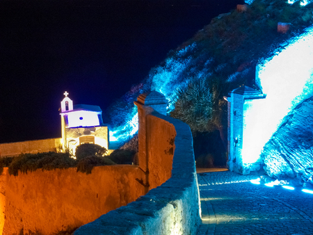 Corsica, France: small church on the walls of Bonifacio lit with night lights of various colors