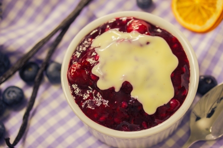 Red fruit compote with custardの写真素材