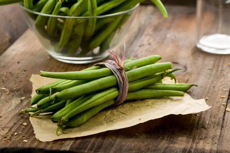 fresh green beans on a wooden backgroundの写真素材