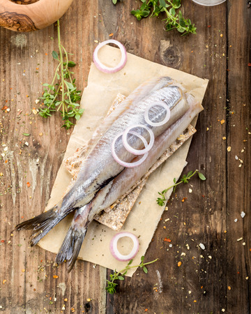 fresh matjes on wooden background with onionsの写真素材