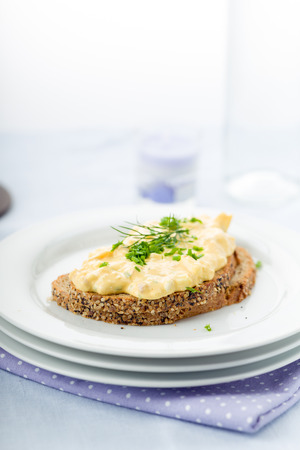 Fresh egg salad with chives and bacon on whole wheat breadの写真素材