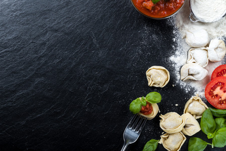 Freshly prepared Tortellini on a slate, with ingredientsの写真素材