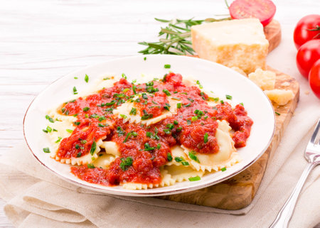 Ravioli with fresh tomato sauce, parmesan cheese and chivesの写真素材