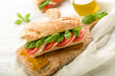 Fresh tomato mozzarella baguette with fresh basilの写真素材
