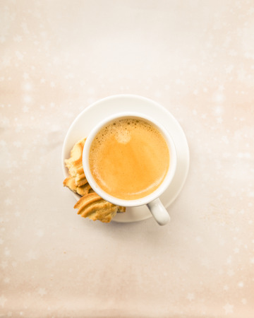 Crema Coffee with biscuits on bright undergroundの写真素材