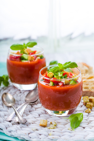 Fresh gazpacho with croutons, basil and fresh cucumberの写真素材