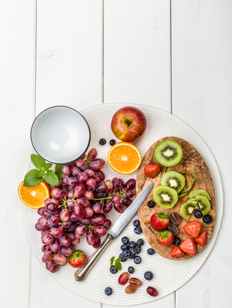 Fresh fruit salad with kiwi, apples, bananas, grapes on a light backgroundの写真素材