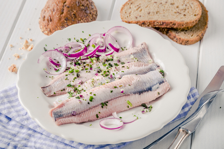Matjes with red onions and fresh breadの写真素材