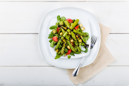 Asparagus salad with balsamic vinegar, croutons and fresh tomatoesの写真素材