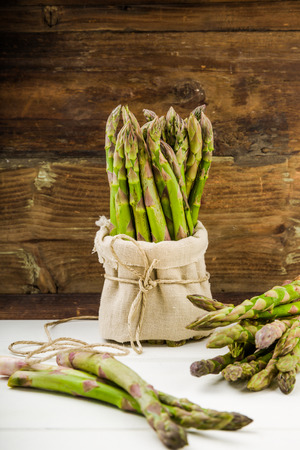 Fresh Green asparagus in a bunch and lots on a backgroundの写真素材