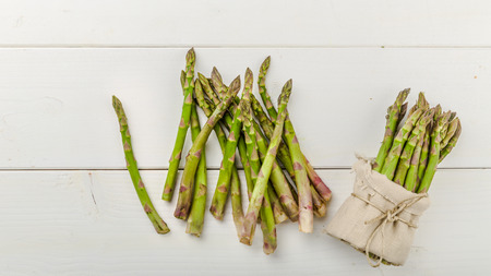 Fresh Green asparagus in a bunch and lots on a backgroundの写真素材