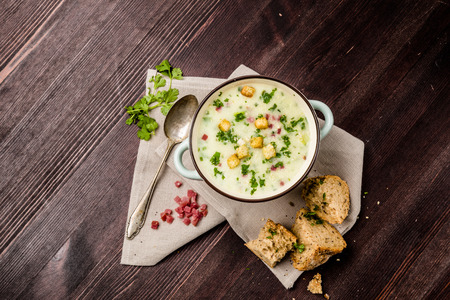 Potato soup with ham, croutons and breadの写真素材
