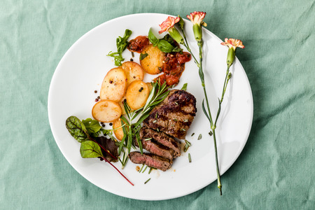 Steak with fried potatoes, bruschetta and rosemaryの写真素材