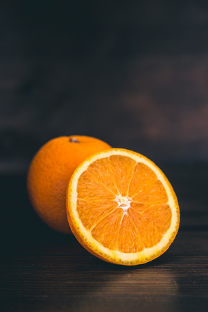 Oranges cut on a dark backgroundの写真素材