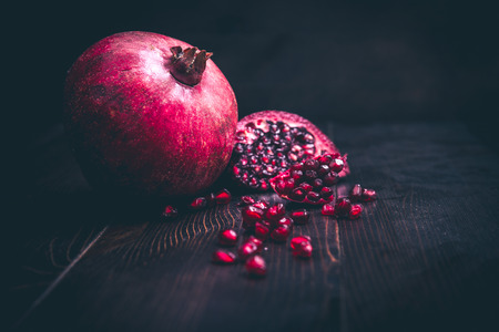 Pomegranate and seeds on dark backgroundの写真素材