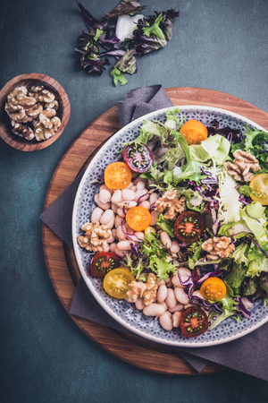 Mixed salad with beans and walnut kernels with tomatoesの写真素材
