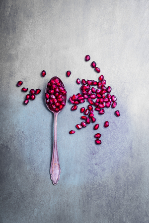 Pomegranate on a spoon and loose coresの写真素材