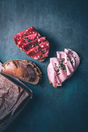 Rustic bread with fresh chorizo salami and mortadella with chivesの写真素材