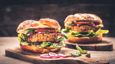 Healthy vegan burger with fresh vegetables and chili sauceの写真素材