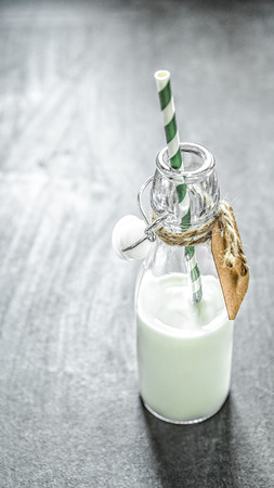 Milk in a bottle with a strawの写真素材