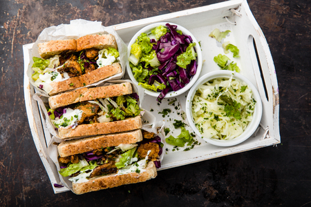delicious gyros sandwich in paper bag with salad and tzatziki, top view,の写真素材