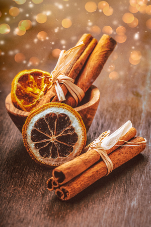 Cinnamon sticks with decoration on a wooden surfaceの写真素材