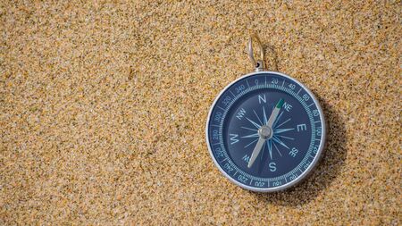 Navigational Compass On Sandy Beach with copy space.